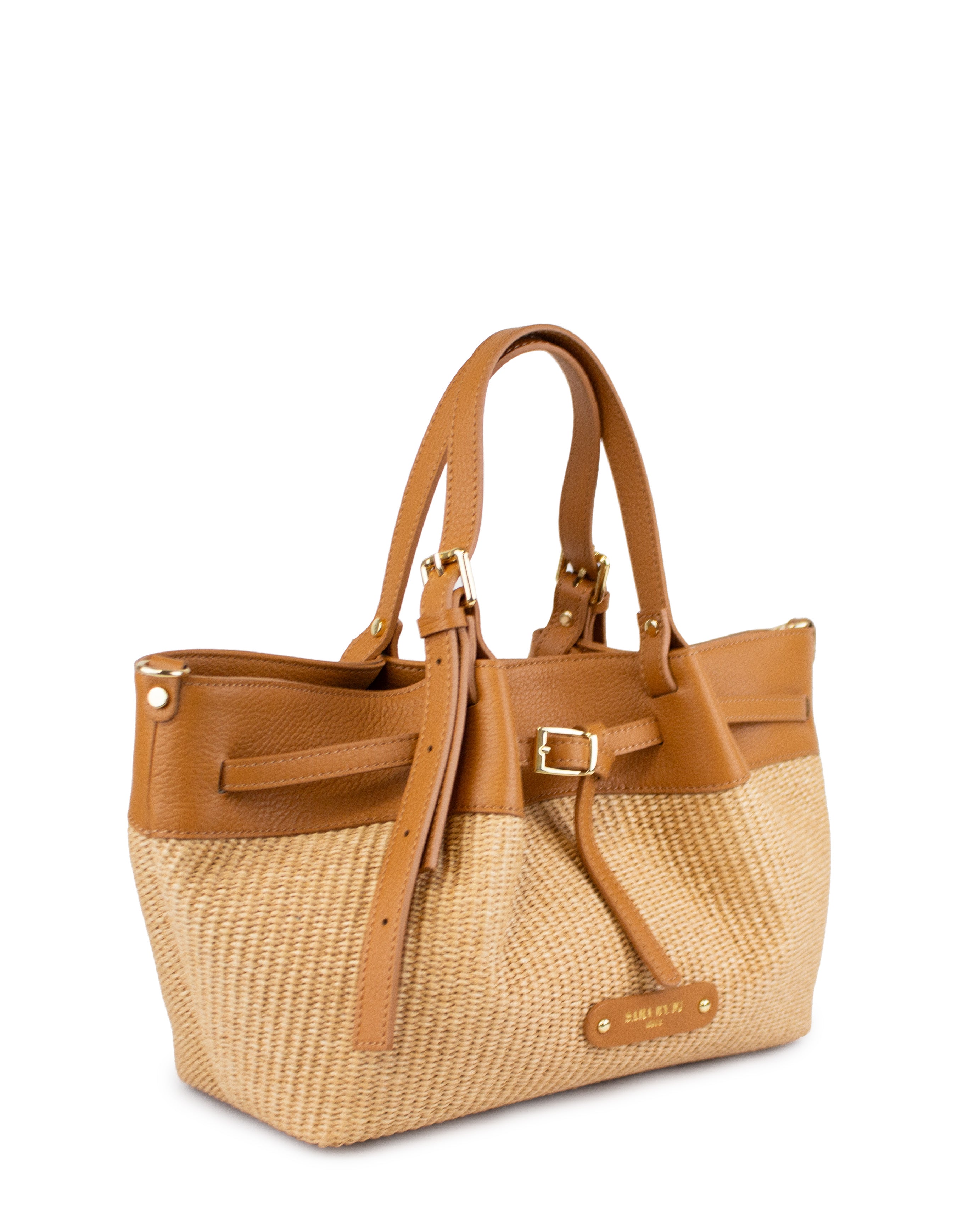 Handcrafted raffia bag with brown leather straps, showcasing an elegant and structured silhouette.
