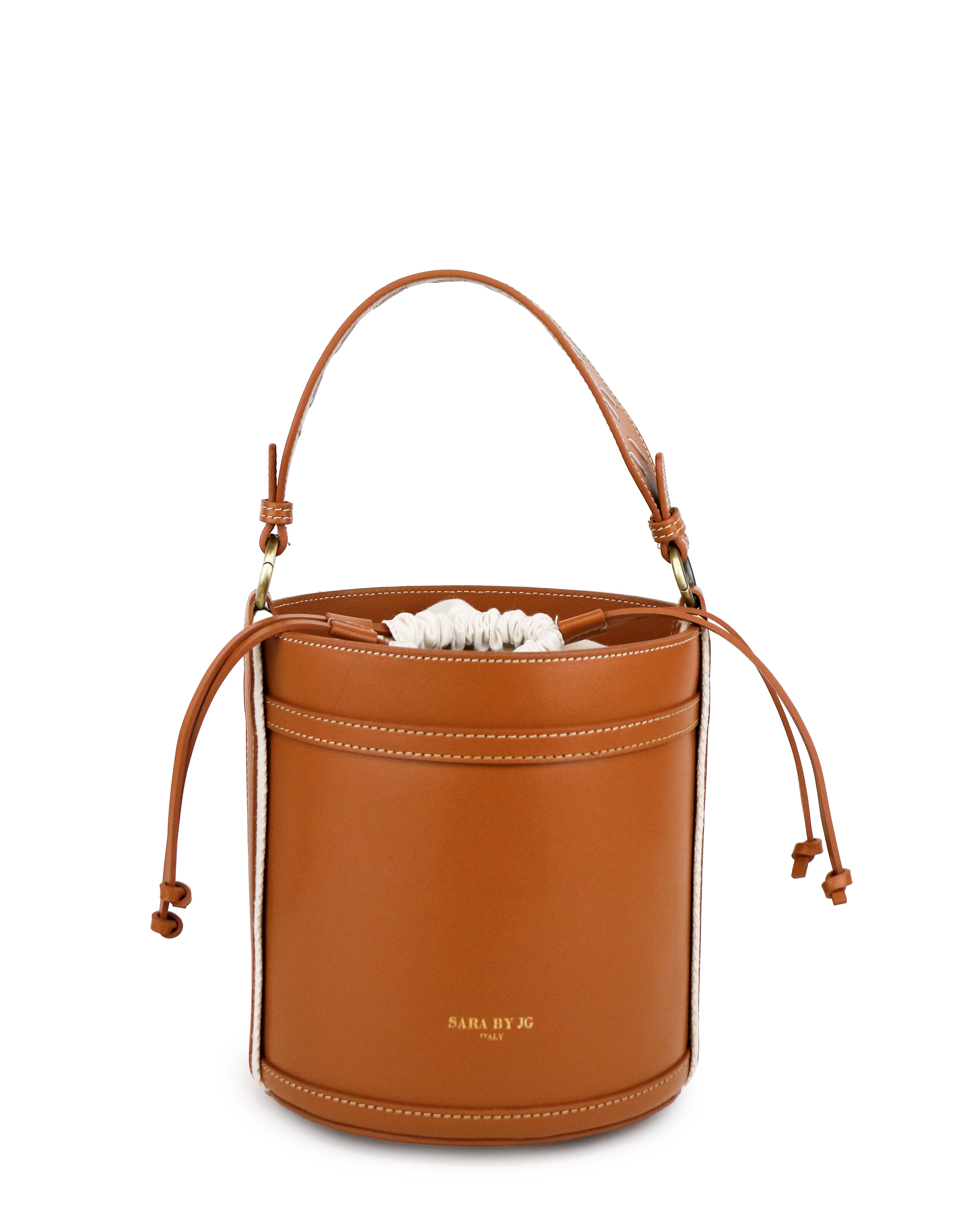 Modern minimalist bucket bag in warm brown leather with adjustable strap and delicate details.