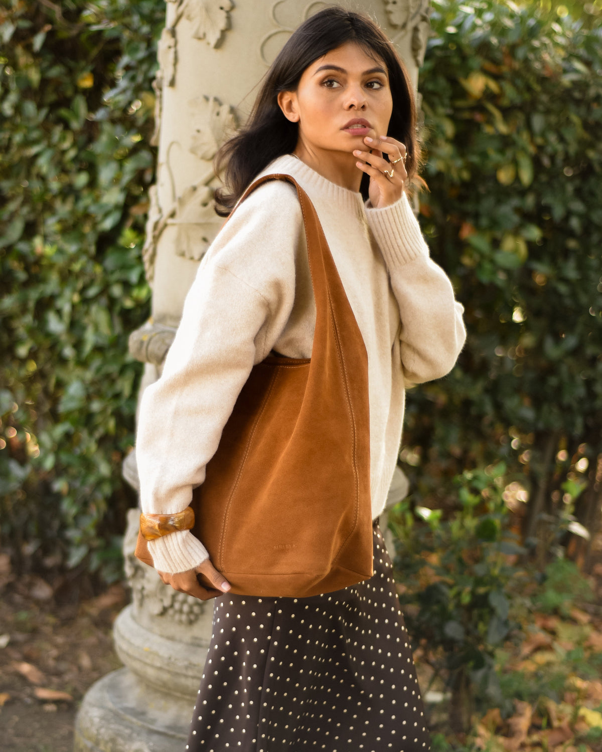 Woman wearing La Sensuale brown suede tote bag for work and university